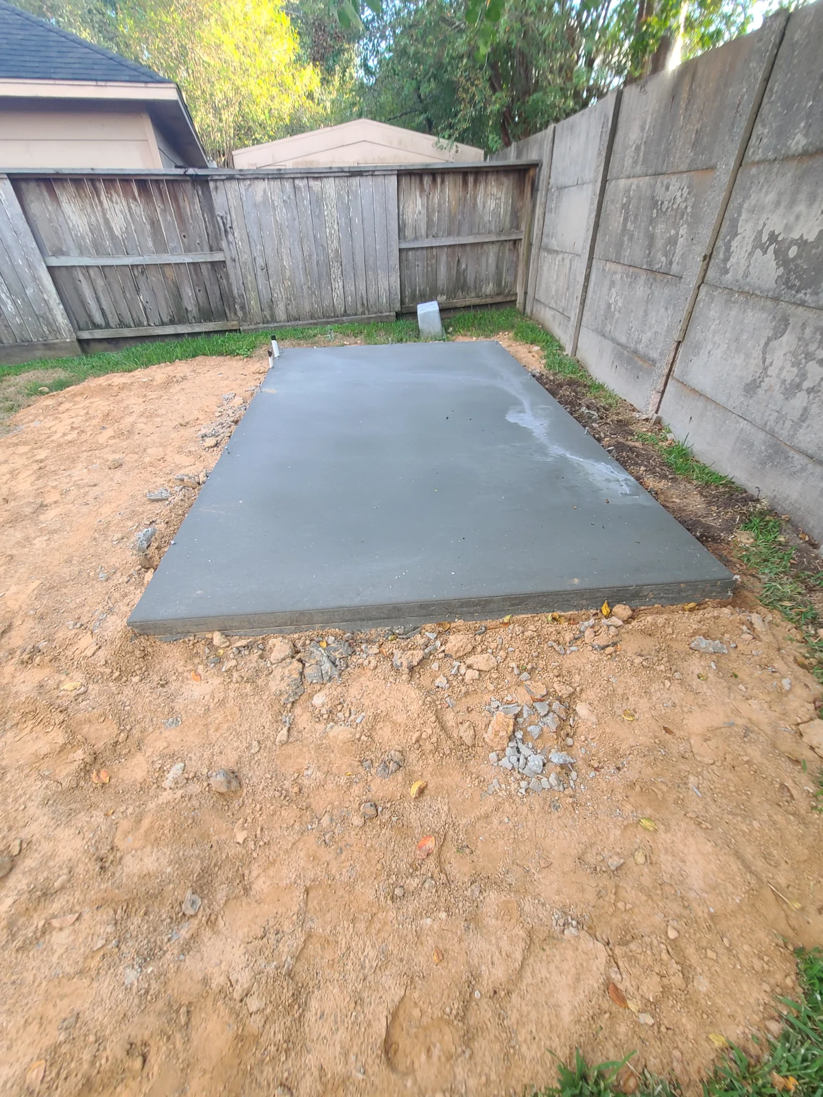 Rectangular concrete slab in a backyard
