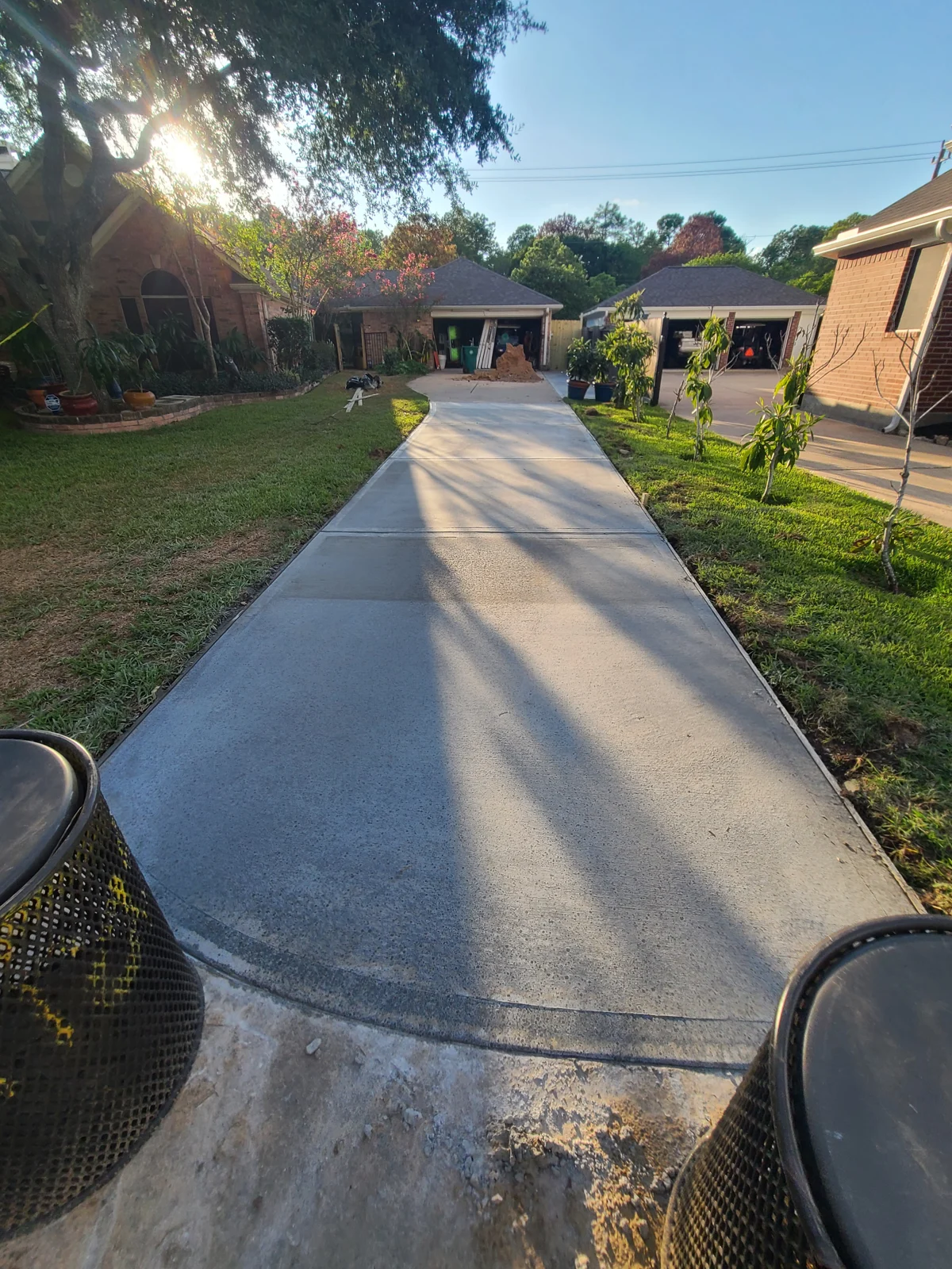 Residential concrete driveway leading toward a garage