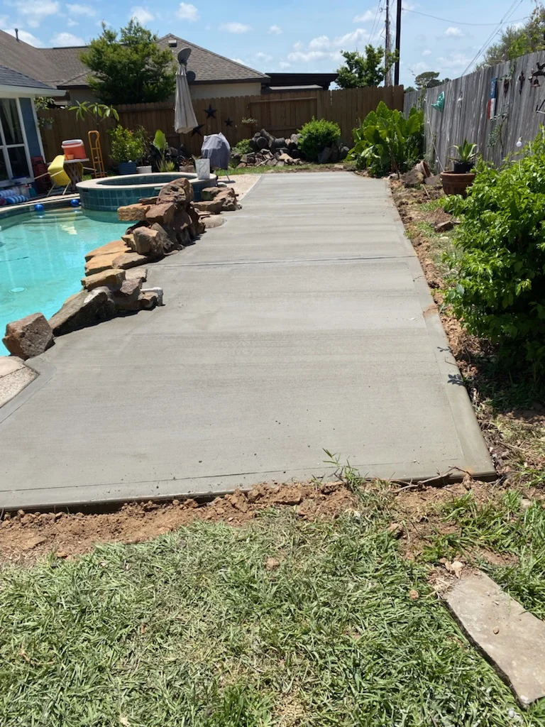 Concrete patio beside a swimming pool
