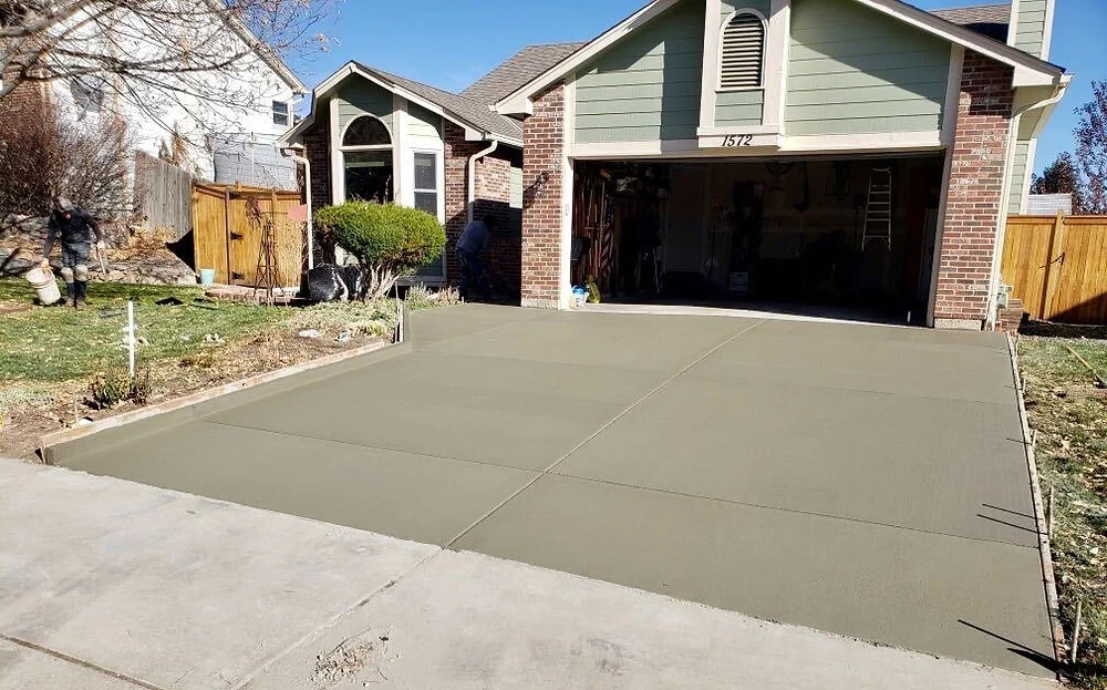 Fresh concrete driveway leading to a residential garage
