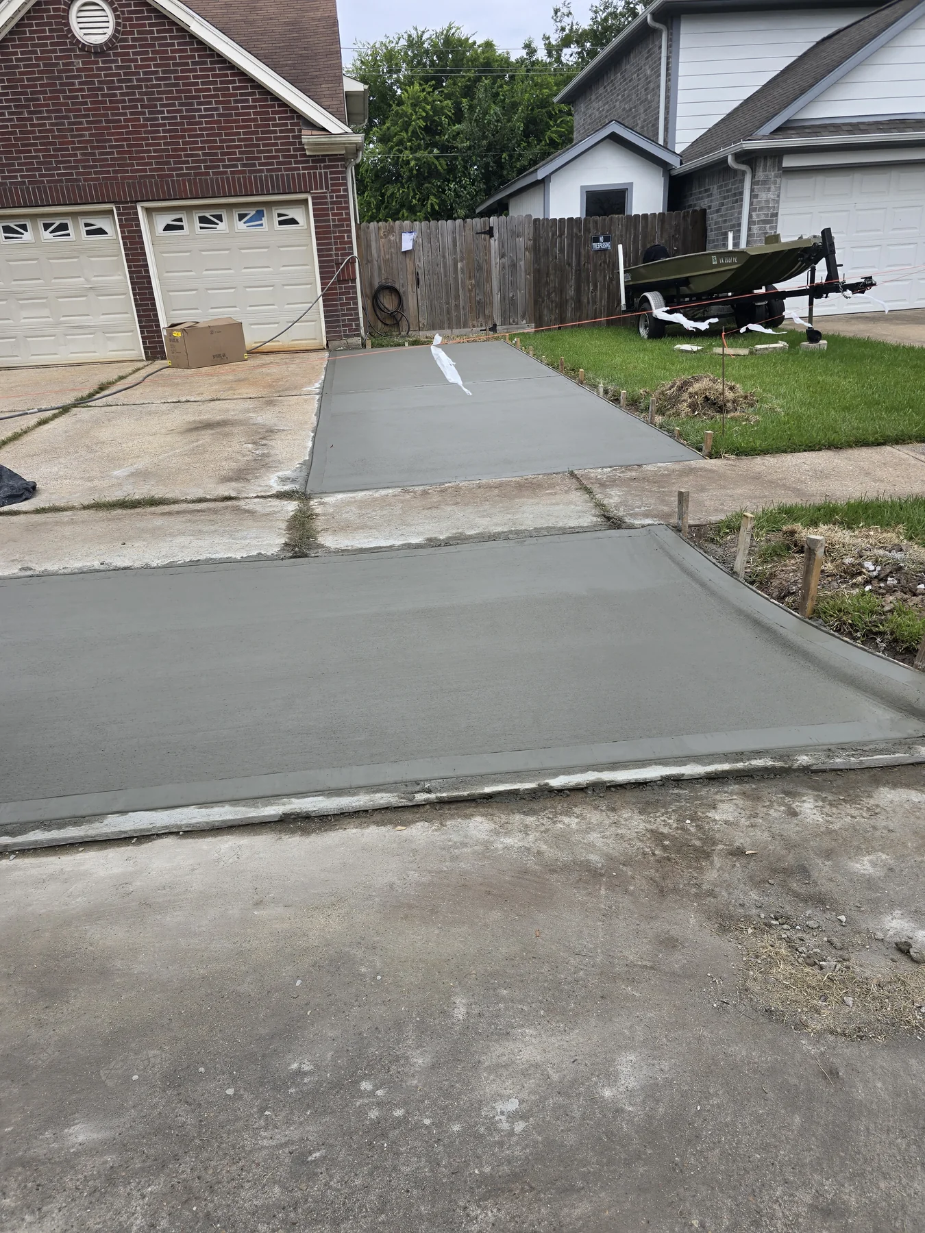 Concrete driveway extension and apron, photographed July 2026