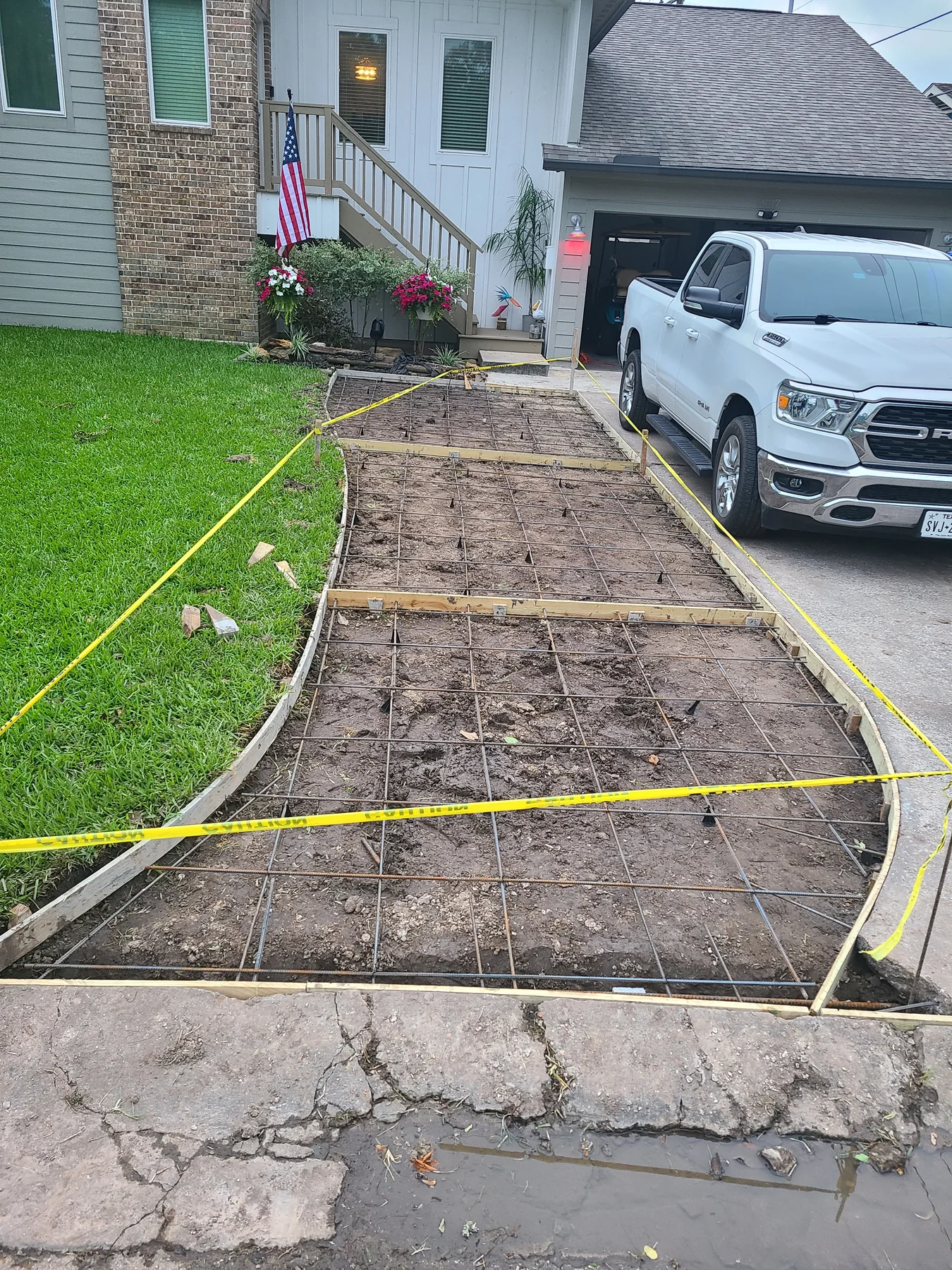 Driveway extension forms and steel reinforcement before the pour, photographed May 2024
