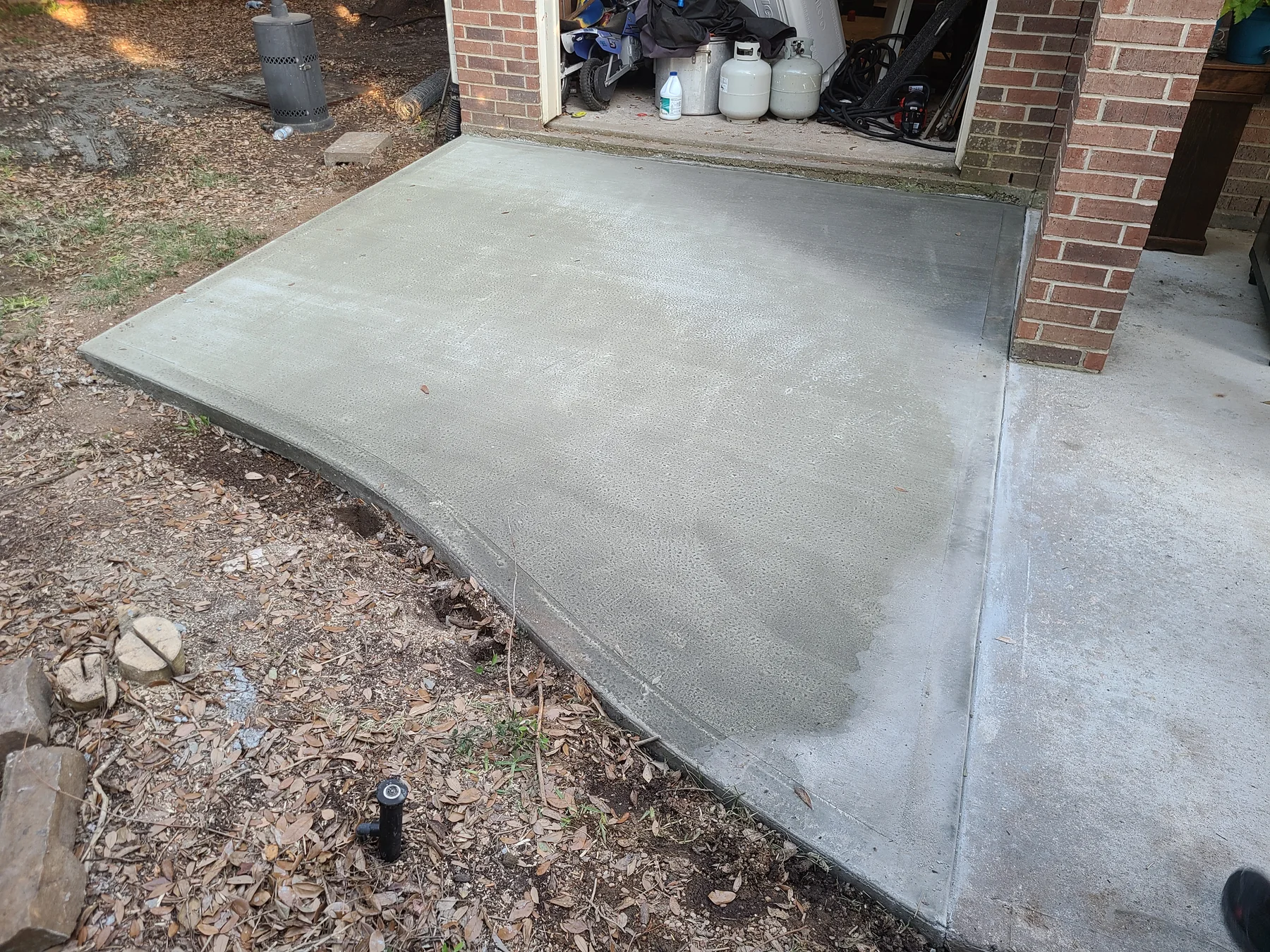 Concrete patio beside a garage by United Concrete