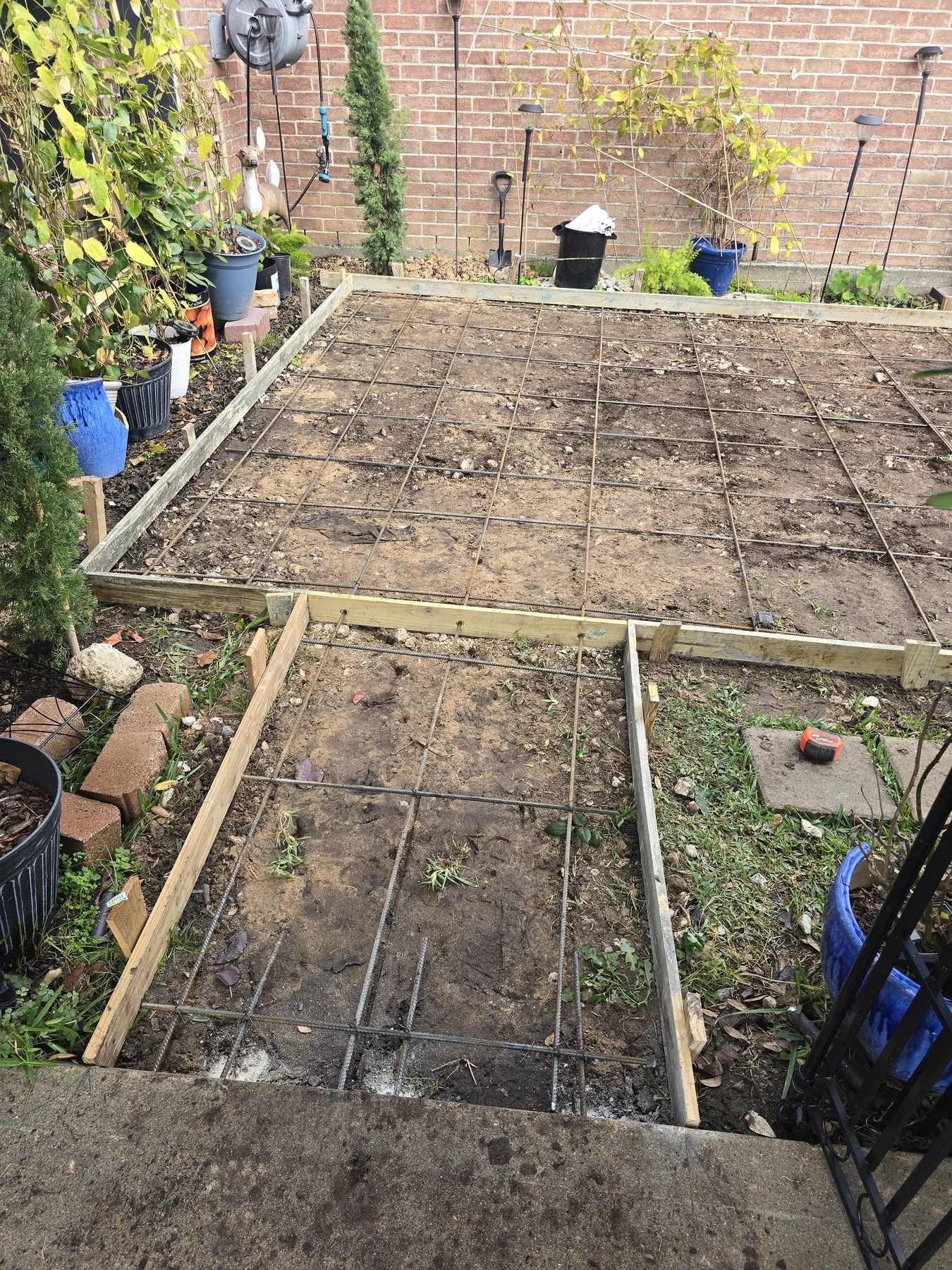 Forms and steel reinforcement for the backyard patio and connecting path before the pour, photographed December 2025