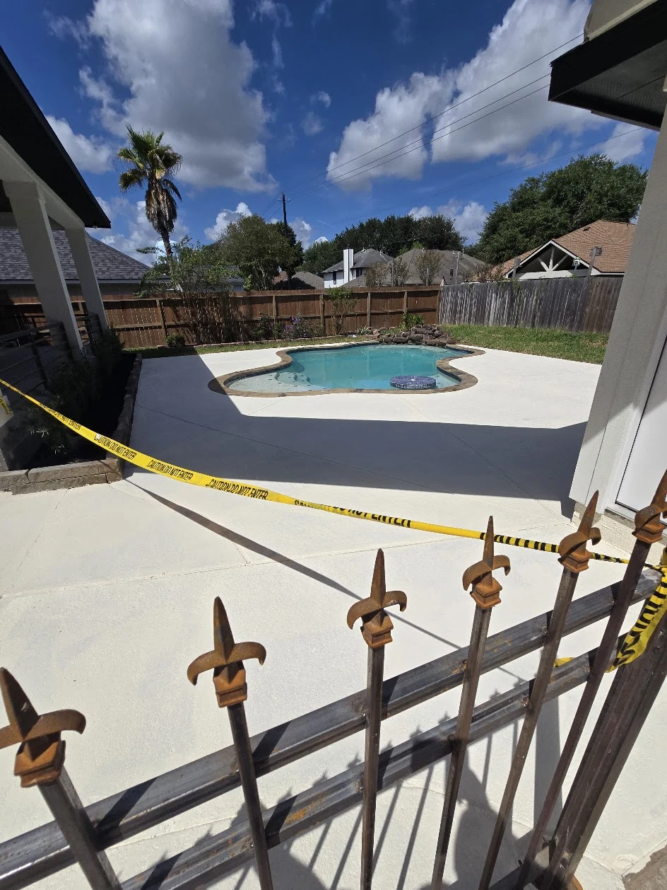 Completed poolside concrete patio and deck, photographed September 2026
