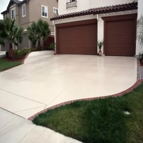 Curved residential driveway with brick border